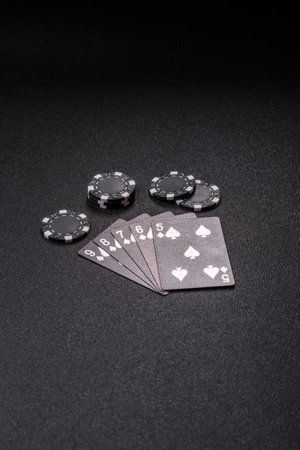 Playing card game poker with chips, bets and risk. Cards and chips on green felt as background for...