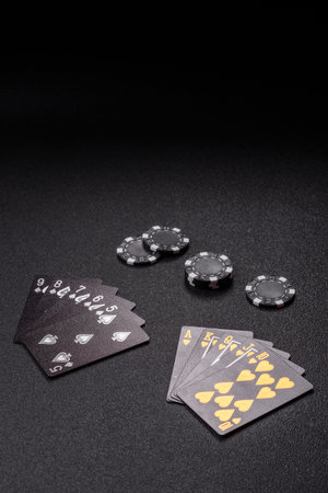 Playing card game poker with chips, bets and risk. Cards and chips on green felt as background for...