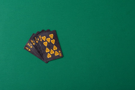 Playing card game poker with chips, bets and risk. Cards and chips on green felt as background for...