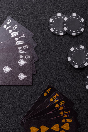 Playing card game poker in casino with chips, bets and risk. Cards and chips on green felt as...