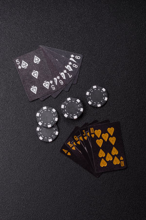Playing card game poker in casino with chips, bets and risk. Cards and chips on green felt as...