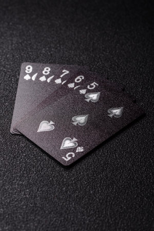 Playing card game poker with chips, bets and risk. Cards and chips on green felt as background for...