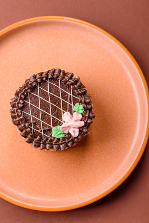 Sweet tart, pie with chocolate and cream with fruit filling on a plate. Chocolate tart dessert for a...
