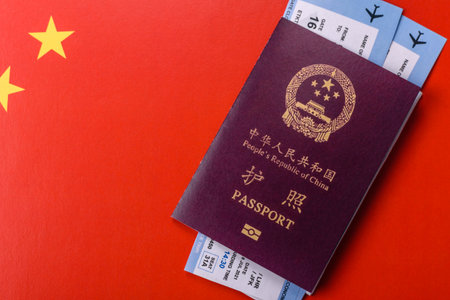 China, Chinese passport with money and flight tickets. Chinese passport with tickets as a background...