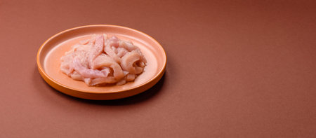 Raw chicken meat cut into strips, fresh fillet or breast slices. Chicken raw meat in pieces as a...