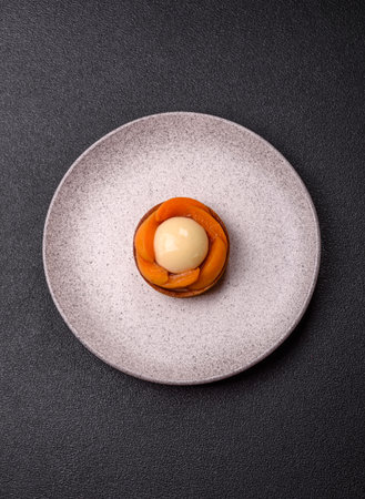 Pie, sweet round tart with apricot pieces, cream and nuts. Sweet tart with peach as a food backgroundの写真素材