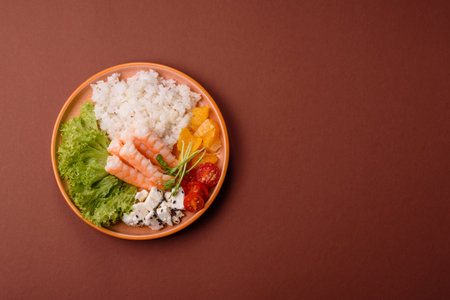 Bowl with shrimps, seafood, rice, tomatoes with sauce. Bowl with prawns as a food background for your designの写真素材