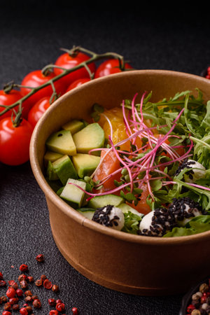 Bowl with salmon pieces, tomatoes, peppers and avocado.