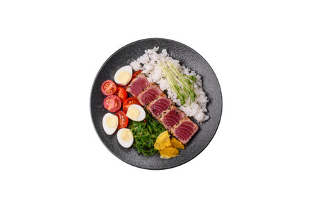 Seafood bowl, tuna tataki fillet slices with rice, oranges, tomatoes and sauce. Tuna bowl as a food...