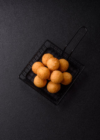 Cheese balls, croquettes or arancini with potatoes or rice. Cheese balls, takeaway, fast food