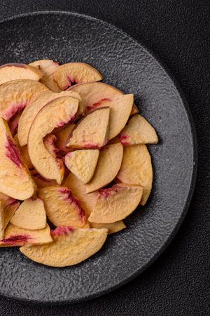 Dried sublimated slices of peach or apricot as an ingredient for sweet desserts. Dried peach as a food background for your designの写真素材