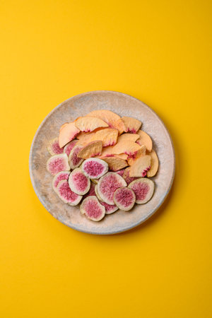 Dried sublimated fig and peach slices as an ingredient for sweet desserts. Dried figs and peaches as...