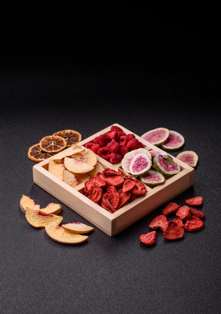 Box of dried fruits strawberries, raspberries, figs and peaches as ingredients for desserts. Dried fruits as food backgroundの写真素材