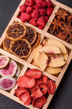 Box of dried fruits strawberries, raspberries, figs and peaches as ingredients for desserts. Dried...