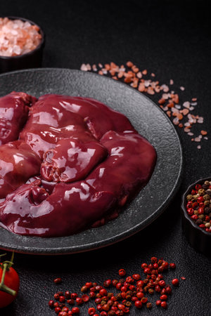 Raw fresh chicken or turkey liver, internal offal of poultry as an ingredient for cooking. Raw chicken liver as a food backgroundの写真素材