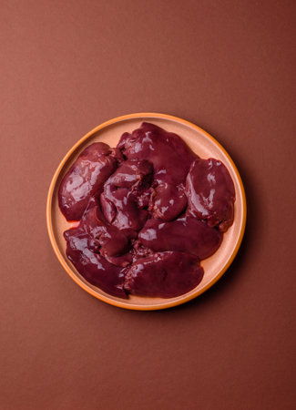 Raw fresh chicken or turkey liver, internal offal of poultry as an ingredient for cooking. Raw chicken liver as a food backgroundの写真素材