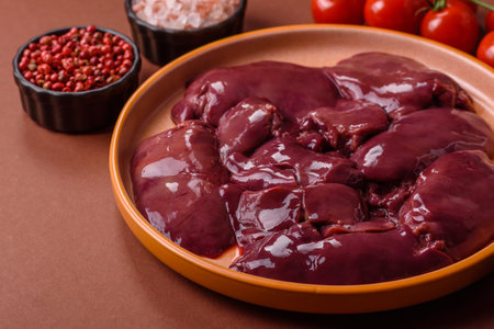 Raw fresh chicken or turkey liver, internal offal of poultry as an ingredient for cooking. Raw chicken liver as a food backgroundの写真素材