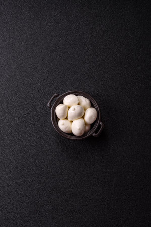 Mozzarella cheese balls, fresh white mini slices as an ingredient for Mediterranean food. Mozzarella cheese as a background for your designの写真素材