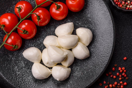 Mozzarella cheese balls, fresh white mini slices as an ingredient for Mediterranean food. Mozzarella cheese as a background for your designの写真素材