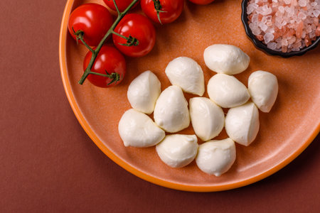 Mozzarella cheese balls, fresh white mini slices as an ingredient for Mediterranean food. Mozzarella cheese as a background for your designの写真素材