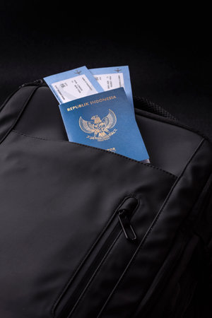 Indonesia passport, visa for travel, document with tickets in travel bag. Indonesian passport as...