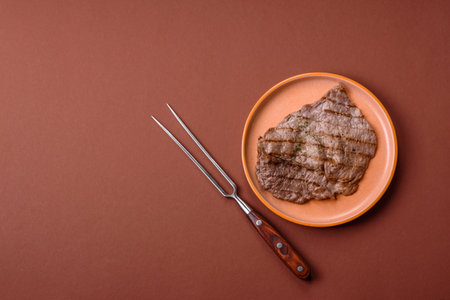 Grilled beef steak, meat cooked on barbecue with salt and pepper. Grilled beef steak as food backgroundの写真素材