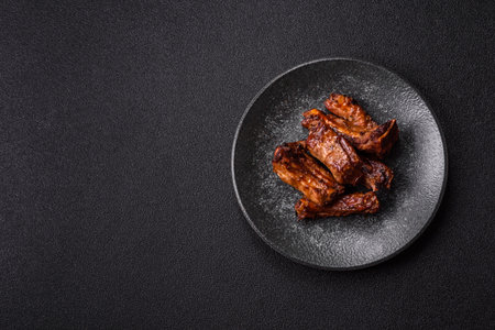 Grilled beef or pork ribs, meat cooked on a barbecue with salt and pepper. Grilled ribs as a food backgroundの写真素材