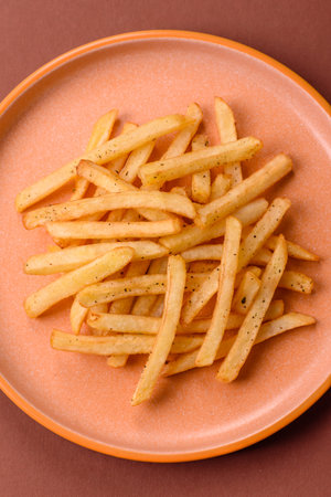 Crispy French fries with sauce, fast food, snack or chips. French fries, takeaway food, background...