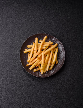 Crispy French fries with sauce, fast food, snack or chips. French fries, takeaway food, background...
