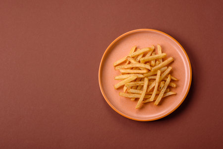 Crispy French fries with sauce, fast food, snack or chips. French fries, takeaway food, background for your designの写真素材