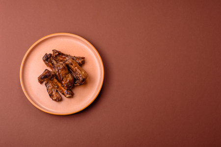 Grilled beef or pork ribs, meat cooked on a barbecue with salt and pepper. Grilled ribs as a food backgroundの写真素材