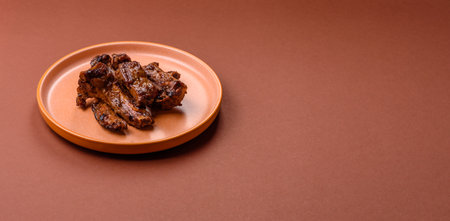 Grilled beef or pork ribs, meat cooked on a barbecue with salt and pepper. Grilled ribs as a food backgroundの写真素材