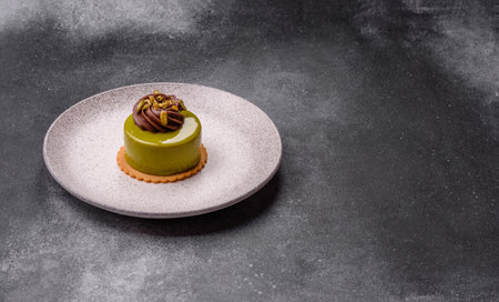 Pistachio cake or tart topped with green mousse with nuts and fruit filling. Pistachio pie as a food...