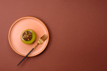 Pistachio cake or tart topped with green mousse with nuts and fruit filling. Pistachio pie as a...