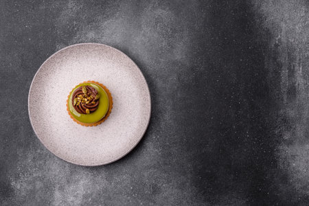 Pistachio cake or tart topped with green mousse with nuts and fruit filling. Pistachio pie as a food...