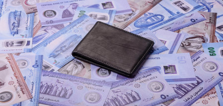 UAE money, dirhams, cash arabic banknotes for financial and business processes. Emirates cash as a...
