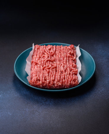Raw ground beef or pork, prepared meat for burgers or other food preparation. Raw ground beef as a...