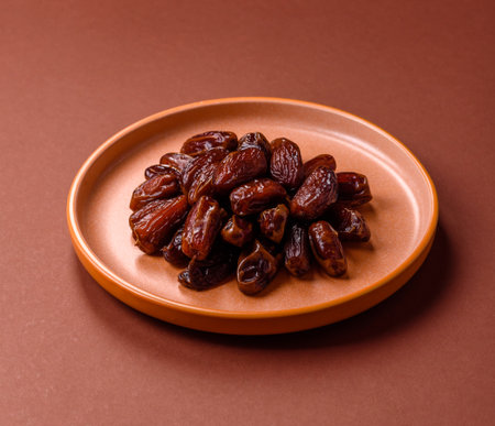 Dried dates in a ceramic plate, arabic food for the ramadan table. Dried dates as a food backdrop...