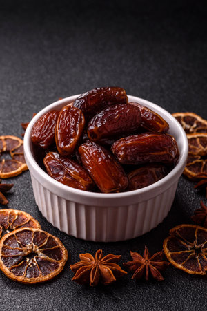Dried dates in a ceramic plate, food for the table. Dried dates as a food backdrop for your design.