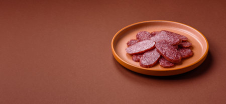 Sliced salami sausage, smoked meat as a delicacy for the table. Salami sausage as a food background...