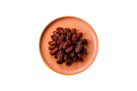 Dried dates in a ceramic plate, arabic food for the ramadan table. Dried dates as a food backdrop for your design.の写真素材