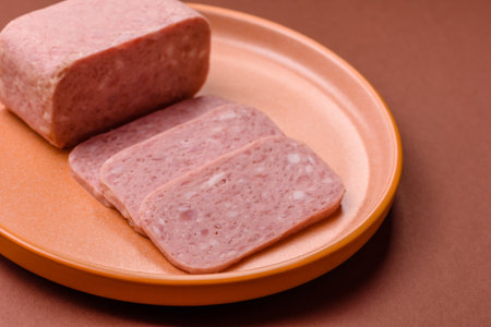 Spiced ham slices, canned meat for lunch sandwiches. Spiced ham as a food backdrop for your design.の写真素材