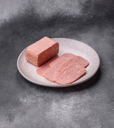 Spiced ham slices, canned meat for lunch sandwiches. Spiced ham as a food backdrop for your design.