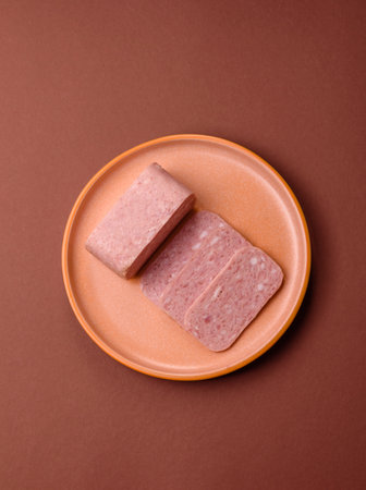 Spiced ham slices, canned meat for lunch sandwiches. Spiced ham as a food backdrop for your design.の写真素材