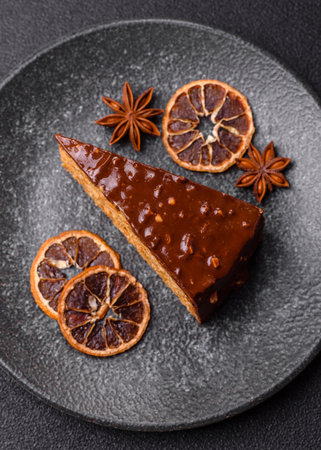 A slice of sweet layered cake covered in chocolate with nuts and caramel. A slice of chocolate cake...
