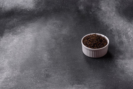 Black tea, dried leaves of a Chinese or Indian breakfast drink. Black tea dried leaves as a food backdrop for your designの写真素材