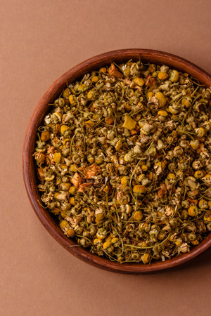 Dried chamomile flowers, herbal tea in a bowl for a hot morning drink. Dried chamomile as a background for your design.の写真素材