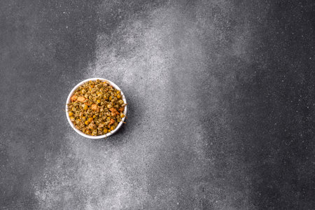 Dried chamomile flowers, herbal tea in a bowl for a hot morning drink. Dried chamomile as a...