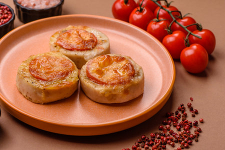 Round fish or chicken cutlets baked with tomato and cheese.
