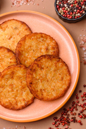 Potato hash browns, a cooked vegetable breakfast food. Potato hash browns as a food background for...